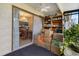Enclosed porch with boxes and shelving near dining area with outdoor view at 6303 23Rd N St, St Petersburg, FL 33702