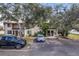 Charming townhome with assigned parking, mature trees, and a welcoming entrance at 6303 23Rd N St, St Petersburg, FL 33702