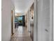 Hallway with tile flooring, closet, and view of the adjacent dining and kitchen areas at 6303 23Rd N St, St Petersburg, FL 33702