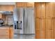 Gourmet kitchen boasts a stainless steel refrigerator, and custom wood cabinetry for ample storage at 6303 23Rd N St, St Petersburg, FL 33702