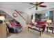 Inviting living room with neutral carpet, ceiling fan, and staircase leading to the upper level at 6303 23Rd N St, St Petersburg, FL 33702