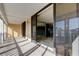 Inviting balcony with sliding glass doors, leading into the living room with tiled floors at 6500 Sunset Way # 202, St Pete Beach, FL 33706