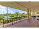 Spacious covered balcony overlooking lush landscaping and tennis courts provides a relaxing outdoor space at 6500 Sunset Way # 202, St Pete Beach, FL 33706