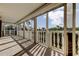 This is a covered balcony featuring white railings and scenic view at 6500 Sunset Way # 202, St Pete Beach, FL 33706