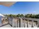 Balcony view showcasing lush tropical foliage, swaying palms, and clear blue skies in a serene outdoor setting at 6500 Sunset Way # 202, St Pete Beach, FL 33706
