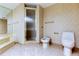 Bathroom featuring a separate glass-enclosed shower and toilet area at 6500 Sunset Way # 202, St Pete Beach, FL 33706