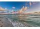 Ocean view with gentle waves lapping on the shore, offering a serene and tranquil atmosphere at 6500 Sunset Way # 202, St Pete Beach, FL 33706