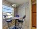 Breakfast nook features a round marble table, stylish seating, and natural light at 6500 Sunset Way # 202, St Pete Beach, FL 33706