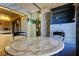 Spacious breakfast nook area featuring a marble-top table and views of the kitchen and building exterior at 6500 Sunset Way # 202, St Pete Beach, FL 33706