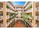Open-air courtyard view of the condominium building, showcasing the architecture and landscaping at 6500 Sunset Way # 202, St Pete Beach, FL 33706