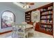 Bright dining area with built-in shelving, decorative items, and arched window at 6500 Sunset Way # 202, St Pete Beach, FL 33706