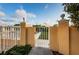 Private gated entry leading to a beautifully landscaped outdoor space and garden at 6500 Sunset Way # 202, St Pete Beach, FL 33706