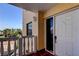 Balcony view of the front door, providing an inviting glimpse of the coastal property at 6500 Sunset Way # 202, St Pete Beach, FL 33706