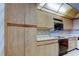 Kitchen features light wood cabinets and countertops with a tiled backsplash at 6500 Sunset Way # 202, St Pete Beach, FL 33706