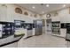 Modern kitchen featuring stainless steel appliances, granite counters, and white cabinets at 6500 Sunset Way # 202, St Pete Beach, FL 33706