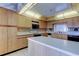 Well-lit kitchen features an island, bright countertops, and plenty of cabinet storage space at 6500 Sunset Way # 202, St Pete Beach, FL 33706