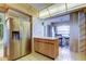 Kitchen has stainless steel refrigerator and breakfast bar with seating at 6500 Sunset Way # 202, St Pete Beach, FL 33706