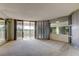 Bright living room with large windows and access to a spacious balcony at 6500 Sunset Way # 202, St Pete Beach, FL 33706