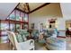 A bright condo lobby with modern furniture, high ceilings, and statement chandelier at 6500 Sunset Way # 202, St Pete Beach, FL 33706