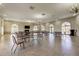 Large meeting room featuring neutral decor, chandeliers, and several tables and chairs at 6500 Sunset Way # 202, St Pete Beach, FL 33706