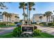 Silver Sands condominium complex entrance with lush landscaping and palm trees, inviting residents and guests at 6500 Sunset Way # 202, St Pete Beach, FL 33706