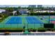 Aerial view of community tennis courts, perfect for recreational activities and social gatherings at 6500 Sunset Way # 202, St Pete Beach, FL 33706