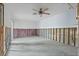 Unfinished room showing exposed framing, ceiling fan, and concrete flooring at 652 Boca Ciega Point N Blvd, St Petersburg, FL 33708