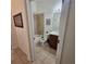 Well-lit bathroom with tiled shower and flooring, and a vanity with brown cabinets at 920 Regal Manor Way, Sun City Center, FL 33573