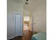 Bright bedroom features wood floors, closet, and entrance to a large, open living space at 920 Regal Manor Way, Sun City Center, FL 33573