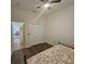 Cozy bedroom with wood floors, large closet, and adjoining doorway to the living room at 920 Regal Manor Way, Sun City Center, FL 33573