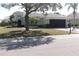 Inviting single-story home features a two-car garage, turret entrance, and mature landscaping for great curb appeal at 920 Regal Manor Way, Sun City Center, FL 33573