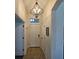 Bright foyer features tiled flooring, recessed lighting, and a stylish chandelier for a grand entrance at 920 Regal Manor Way, Sun City Center, FL 33573