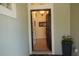 View of the inviting entryway, tiled floors, and a glimpse of the chandelier through the arched doorway at 920 Regal Manor Way, Sun City Center, FL 33573