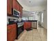 Cherry cabinets and stainless steel appliances enhance this kitchen at 920 Regal Manor Way, Sun City Center, FL 33573