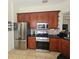 Kitchen featuring stainless steel appliances and dark wood cabinets at 920 Regal Manor Way, Sun City Center, FL 33573