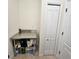 Laundry room with white folding closet and stainless steel counter at 920 Regal Manor Way, Sun City Center, FL 33573