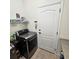 Laundry room with tiled floors and modern gray appliances at 920 Regal Manor Way, Sun City Center, FL 33573