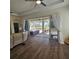 Spacious living room with wood floors, plush furniture, and a view of the screened-in patio at 920 Regal Manor Way, Sun City Center, FL 33573