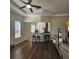Inviting living room with wood floors, ceiling fan, and bar seating at 920 Regal Manor Way, Sun City Center, FL 33573