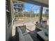 Relax on this screened patio featuring comfortable seating with a beautiful outdoor view at 920 Regal Manor Way, Sun City Center, FL 33573