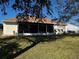 The backyard features a screened in lanai and lush green grass at 9350 Gulfstream, Englewood, FL 34224