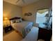 Cozy bedroom with queen-size bed, dresser, and window with natural light at 9350 Gulfstream, Englewood, FL 34224