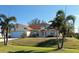 Inviting single-story home with manicured lawn and lush palm trees at 9350 Gulfstream, Englewood, FL 34224