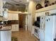 Well-lit kitchen with white cabinets and appliances at 9350 Gulfstream, Englewood, FL 34224