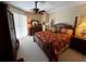 Luxurious main bedroom with a four-poster bed and ample natural light at 9350 Gulfstream, Englewood, FL 34224