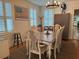 Bright dining room with a chandelier, shuttered windows, an American flag, and seating for six at 417 W Davis Blvd, Tampa, FL 33606