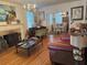 Elegant living room featuring a piano, fireplace, hardwood floors, and connection to the dining room at 417 W Davis Blvd, Tampa, FL 33606