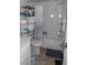 Bright bathroom featuring a shower-tub combo, and linen shelving, with a white cabinet vanity at 1 Quails Run Blvd # 2, Englewood, FL 34223