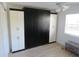 Sleek bedroom showcasing a Murphy bed with white and black storage cabinets at 1 Quails Run Blvd # 2, Englewood, FL 34223