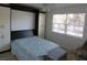 Modern bedroom featuring a Murphy bed with built-in storage and a bright window at 1 Quails Run Blvd # 2, Englewood, FL 34223